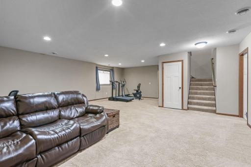 Bright & inviting with egress window + recessed lighting.