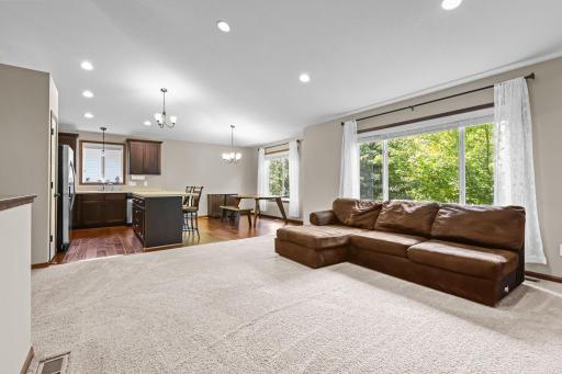 Open-concept layout with soaring vaulted ceilings and seamless flow into kitchen and dining areas.