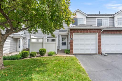 Welcome home! Charming townhome with inviting curb appeal, mature tree, and a private front patio space.
