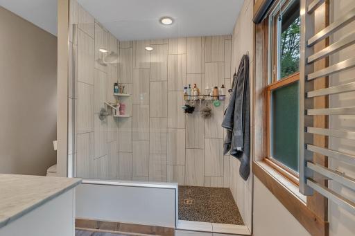Spa-like bathroom includes a custom tile shower with modern design touches.