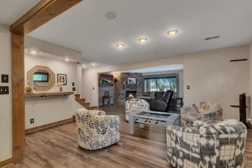 The lower level offers a comfortable sitting area complete with a wet bar and space for game tablesâperfect for entertaining