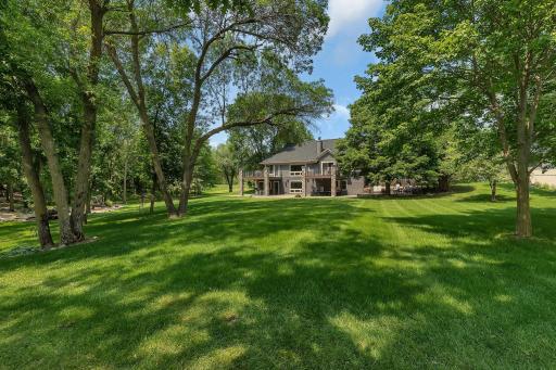 Gently sloping lawn to sandy beach and water.