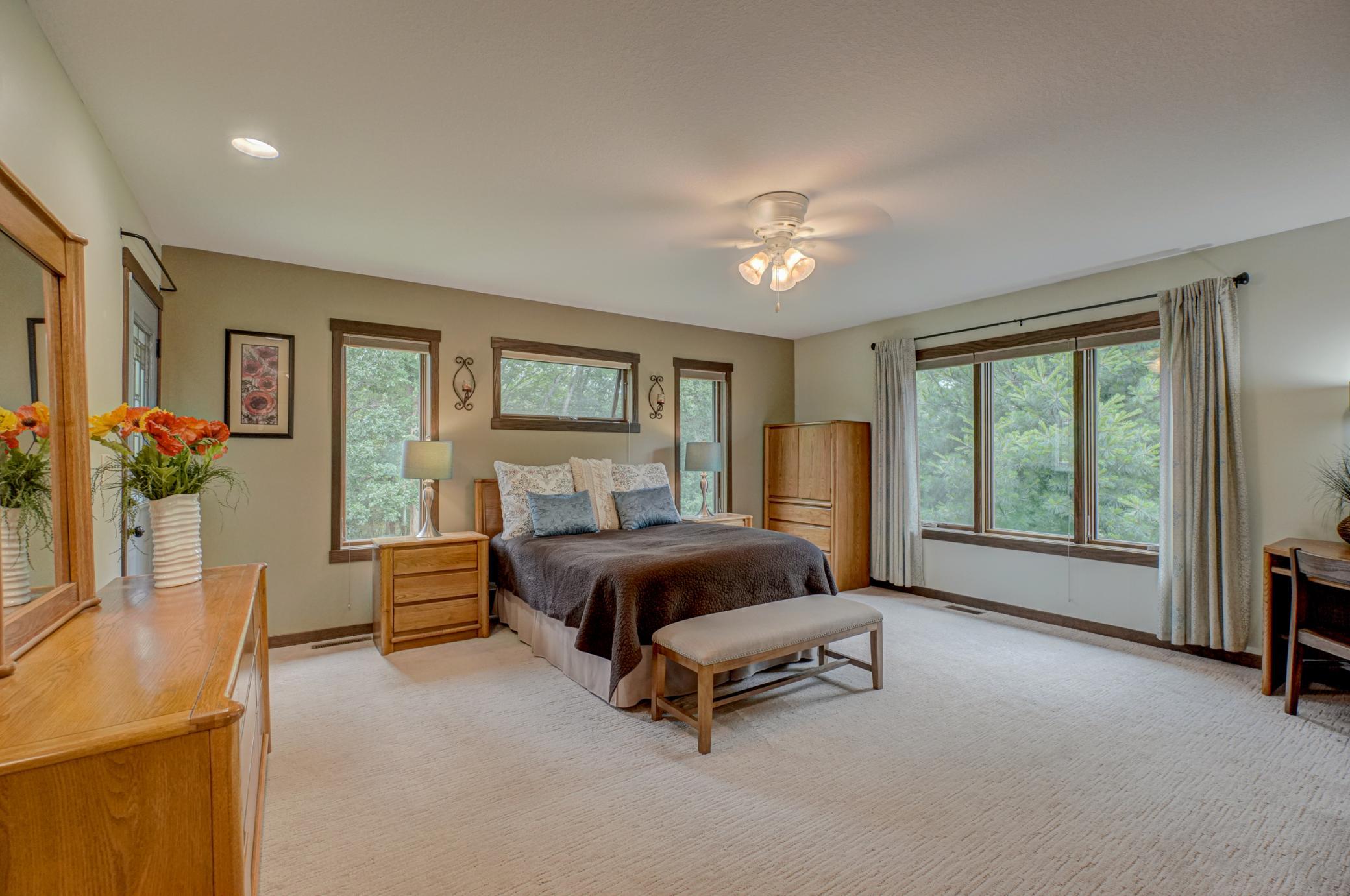 Enjoy main-level living with an impressive owner’s suite featuring a jetted tub, walk-in shower, private balcony, and a spacious walk-in closet with built-ins.