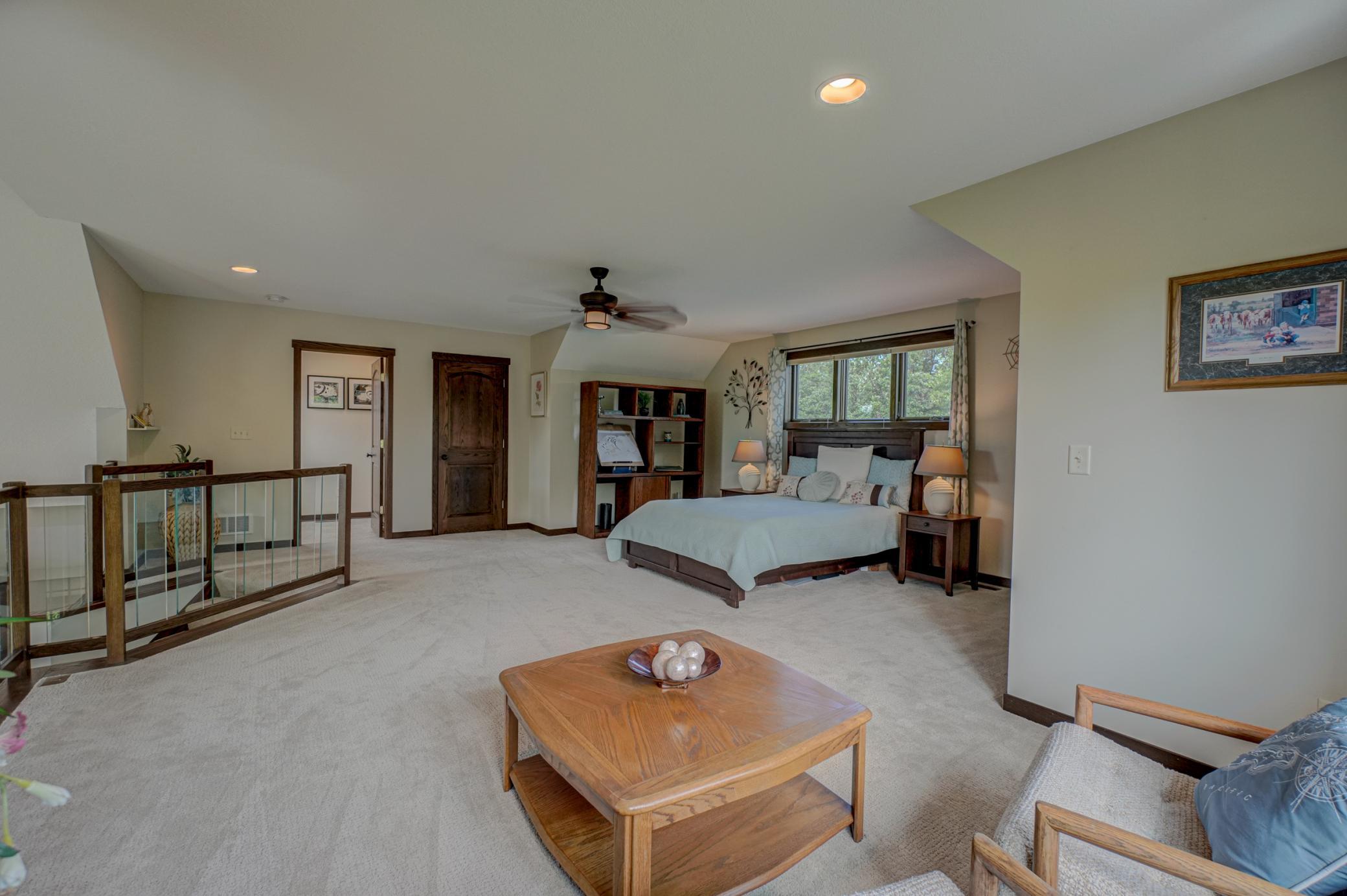 The upstairs loft offers a versatile space with its own bathroom and generous space for lounging, hobbies, or guests.