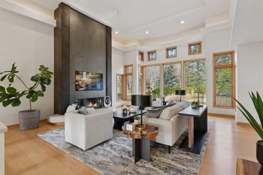 Step into elegance with a great room featuring a stunning floor-to-ceiling tiled fireplace