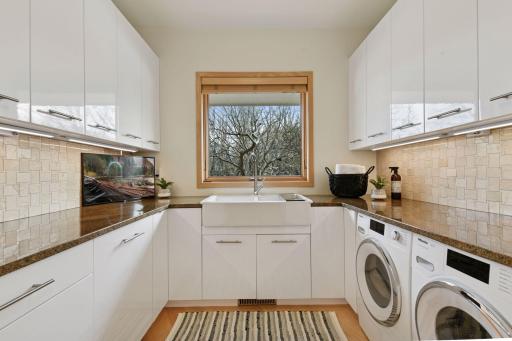 Efficient laundry room design with ample storage from upper and lower cabinets