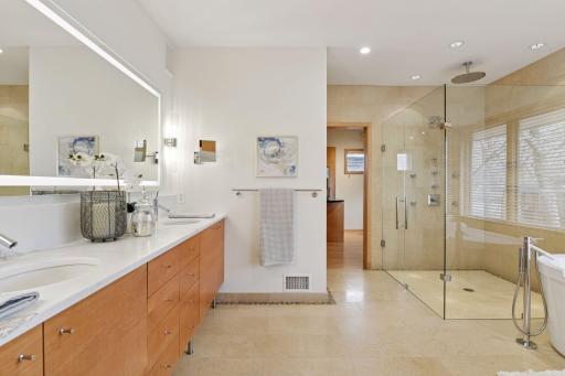 The private primary bath features quartz countertops, Kohler under mount sinks, and plenty of storage space
