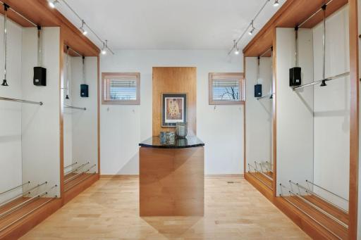 The primary walk-in closet is enhanced with additional custom shelving