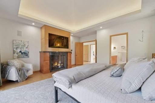 The primary suite features a cozy gas fireplace