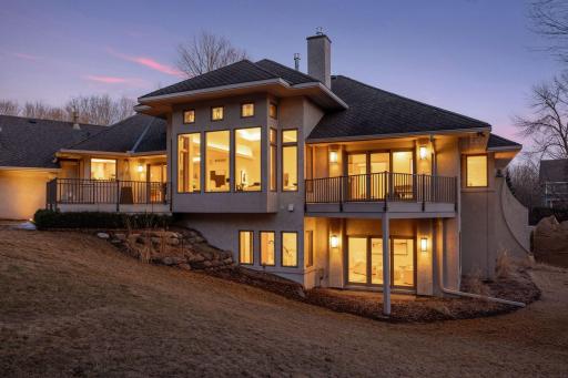 Professional landscape lighting throughout the property, includes in-ground tree lighting and house wall accent lighting