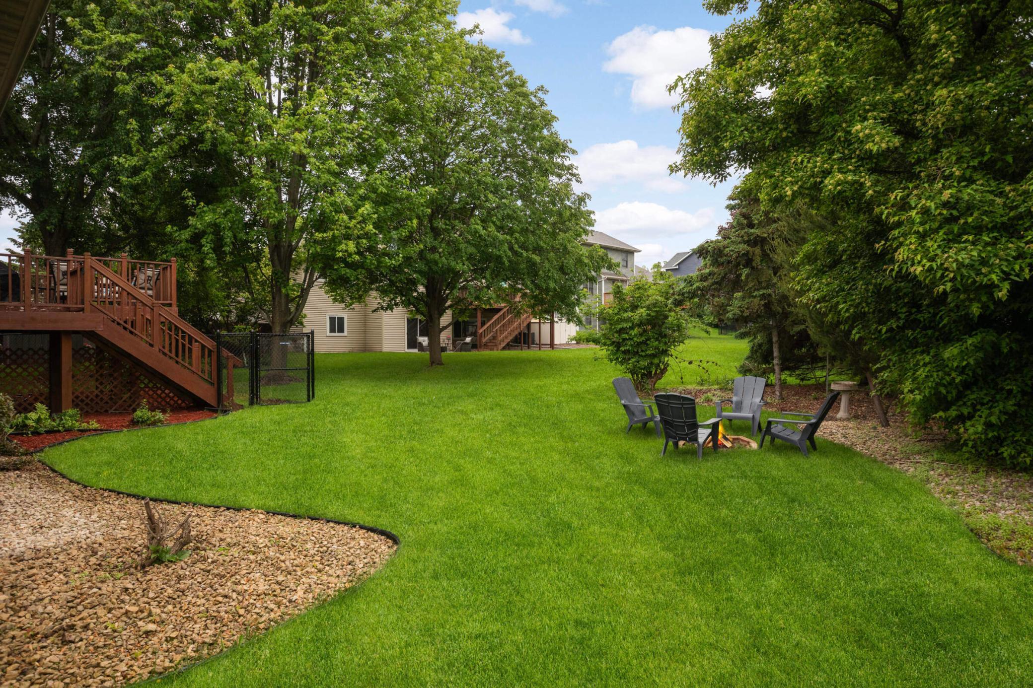 Expansive backyard with large trees makes for a private escape