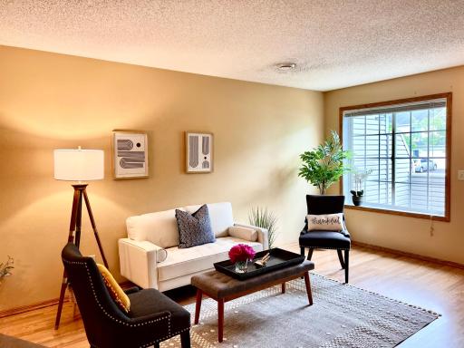The big window lets in lots of light while the shrubs outside create privacy