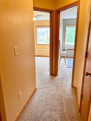 Upper level hallway leading to two more bedrooms