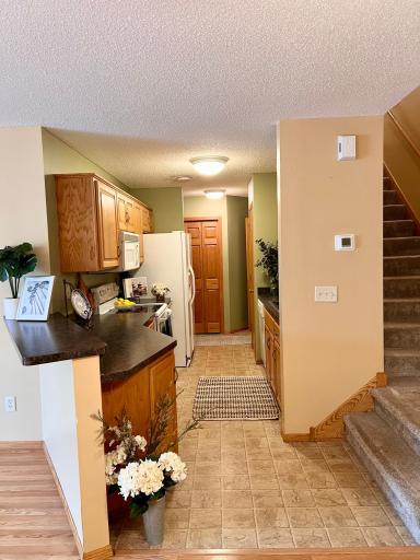 View of the kitchen and stairs from the dining area