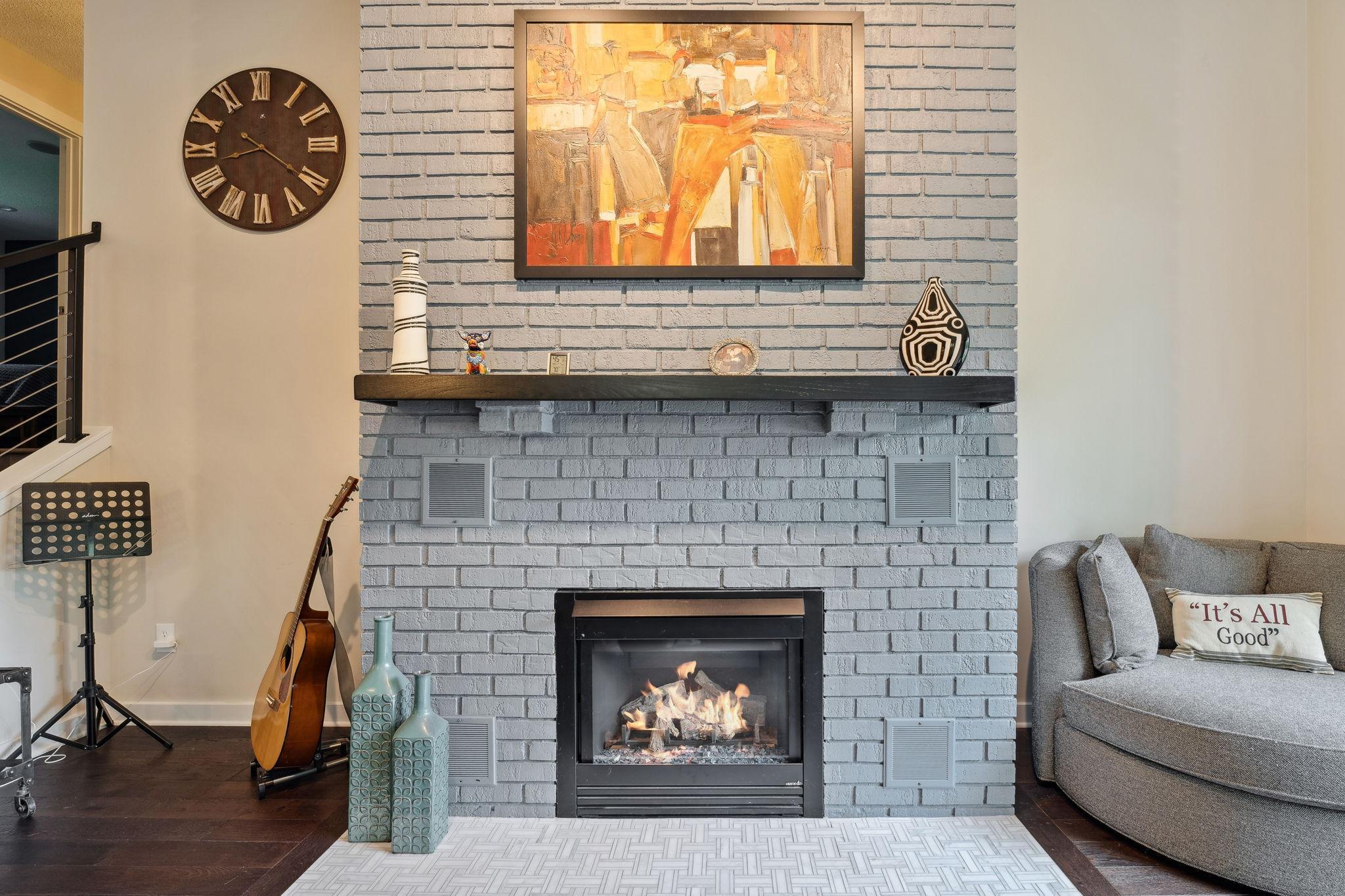 Cozy gas fireplace with a tile hearth and wood mantel.