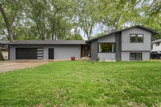 Striking curb appeal with modern updates! This beautifully refreshed home features a sleek, contemporary facade with contrasting tones, a stylish black garage door and a welcoming front entry.