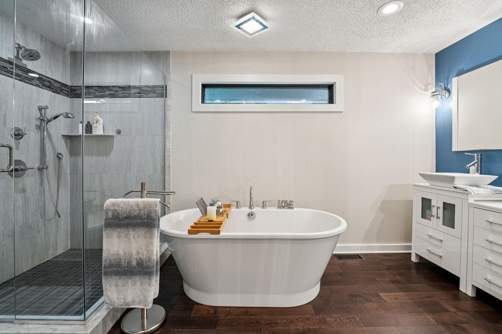 Relax and unwind in the oversized soaking tub or step into the custom tiled walk-in shower.