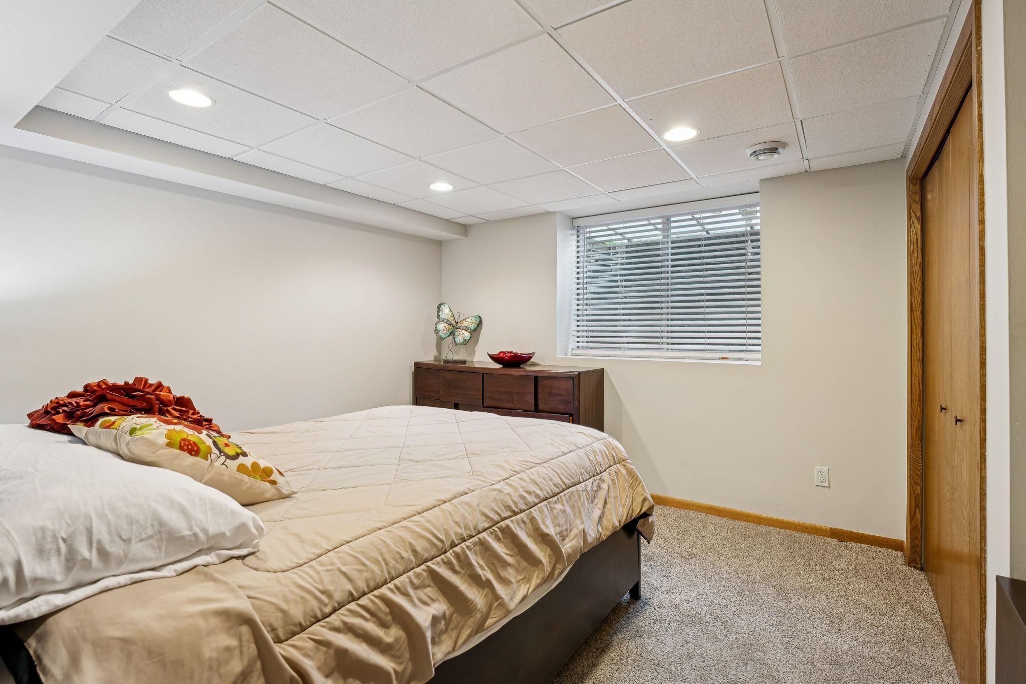 Bedroom #4 offers comfort and functionality with a large egress window that fills the space with natural light. Enjoy plush carpeting, a spacious layout, and a double closet providing ample storage.