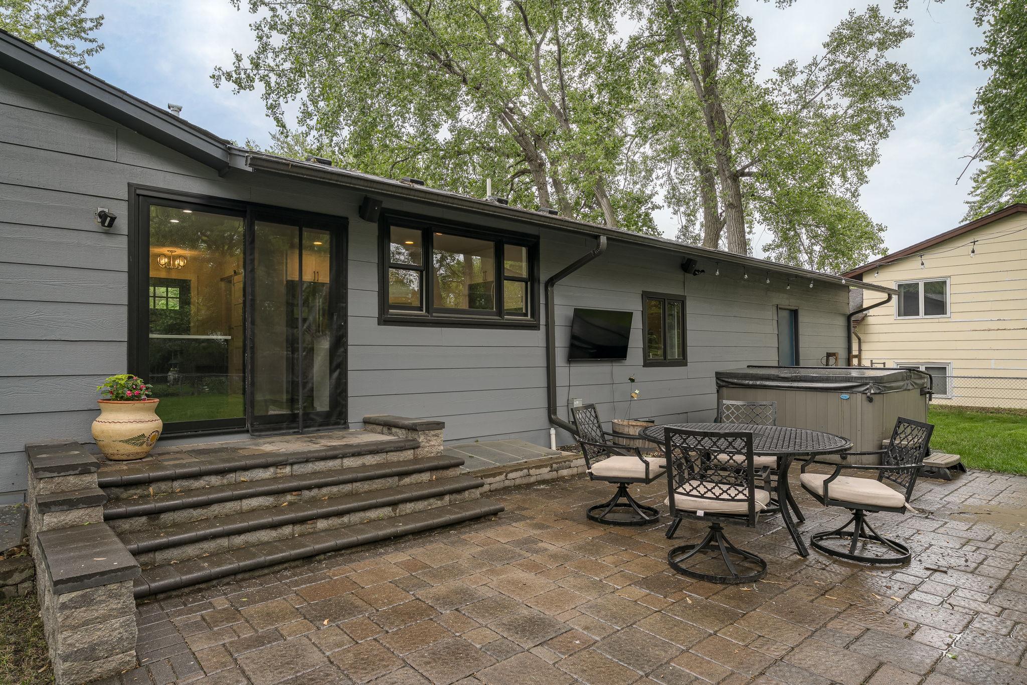 Spacious stone paver patio with built-in steps, perfect for entertaining.