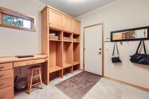 You will love the storage space this mud room offers. Custom storage area + home office desk area, perfect for dropping off the daily mail, or keeping the home calendar. Easy access to garage, which has electric car charger if needed.