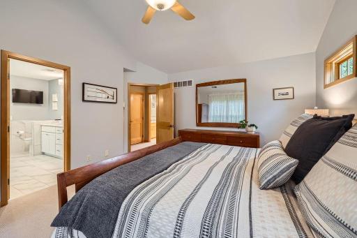 The luxurious primary suite is a serene retreat, with soaring vaulted ceilings, a spacious walk-in closet, and a spa-inspired bath complete with elegant finishes. This will be your private haven!