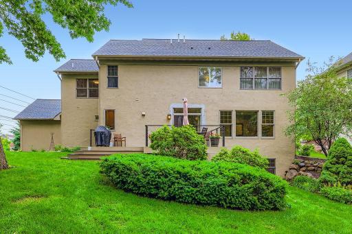 Exterior Rear of home. Lovely landscaping & gorgeous wooded lot.