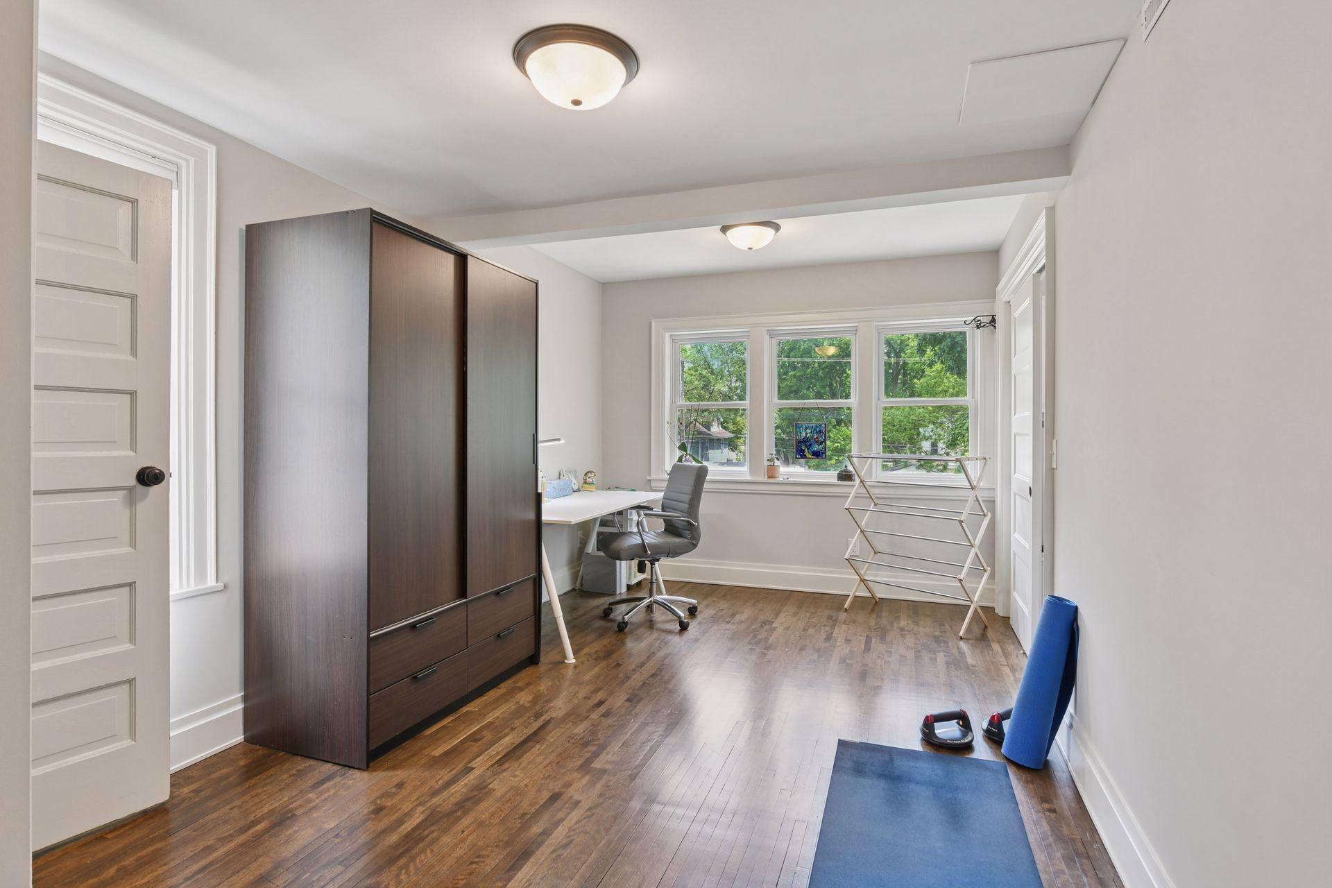 3837 Pleasant Avenue - Flex Room - Door to the left goes to the primary suite on the third level. This room has many uses; office yoga, study... and the laundry room is through the sliding doors on the right.
