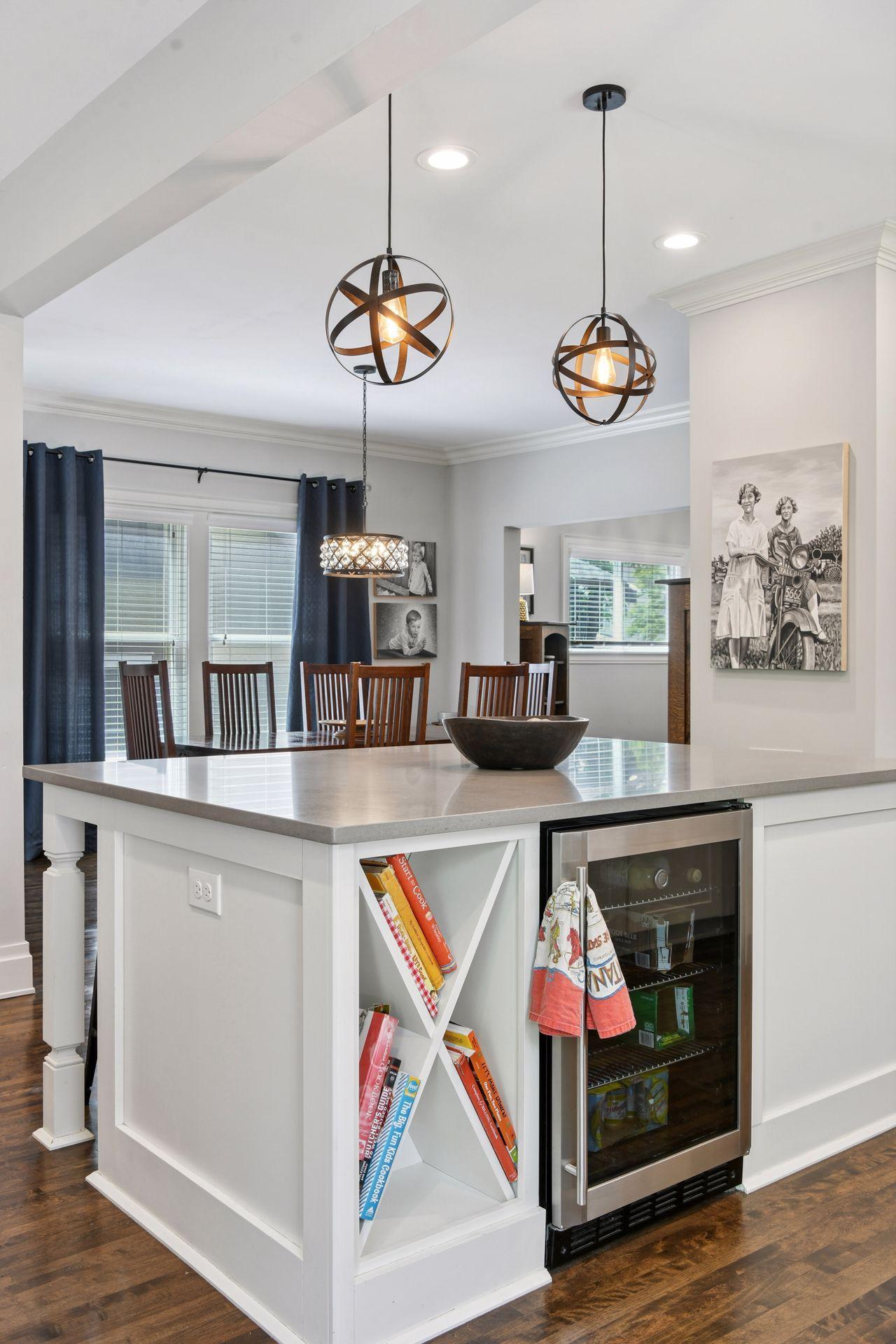 3837 Pleasant Avenue - Island with drawer storage, wine rack/cookbook nook, beverage refrigerator.