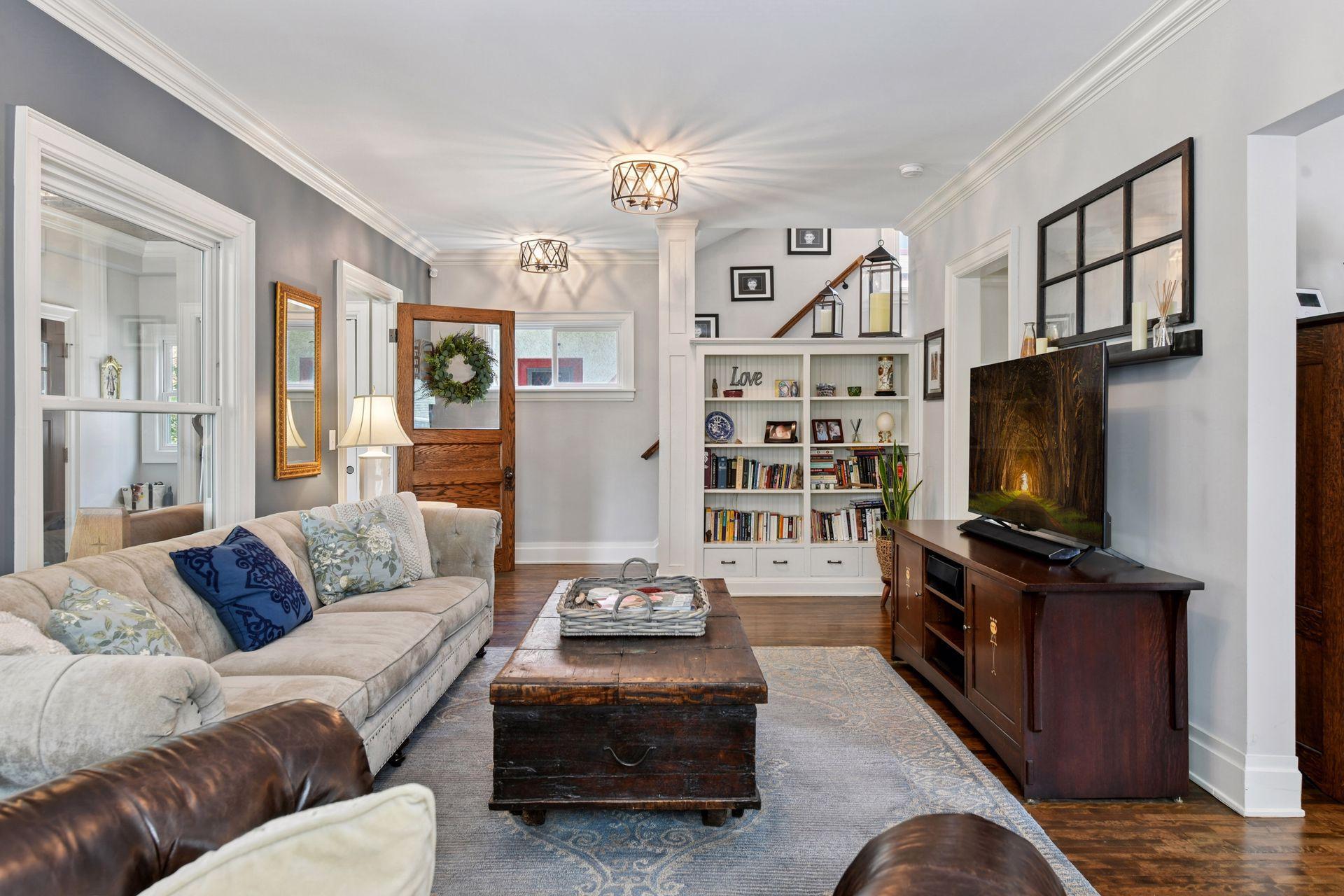 3837 Pleasant Avenue - The Living room - Stunning light-filled space with beautiful architectural details like hardwood flooring, high ceilings and crown molding.
