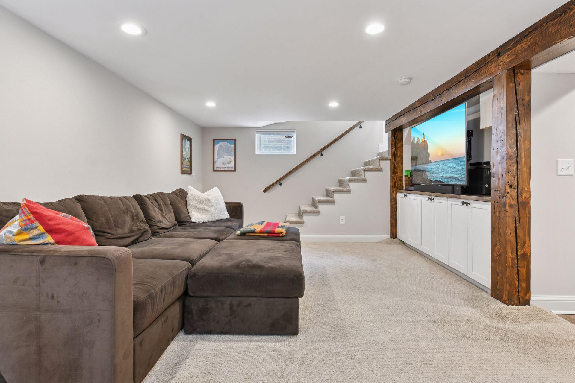 3837 Pleasant Avenue - Lower level Family room - Recessed lighting, rustic beams and built-in media cabinets.