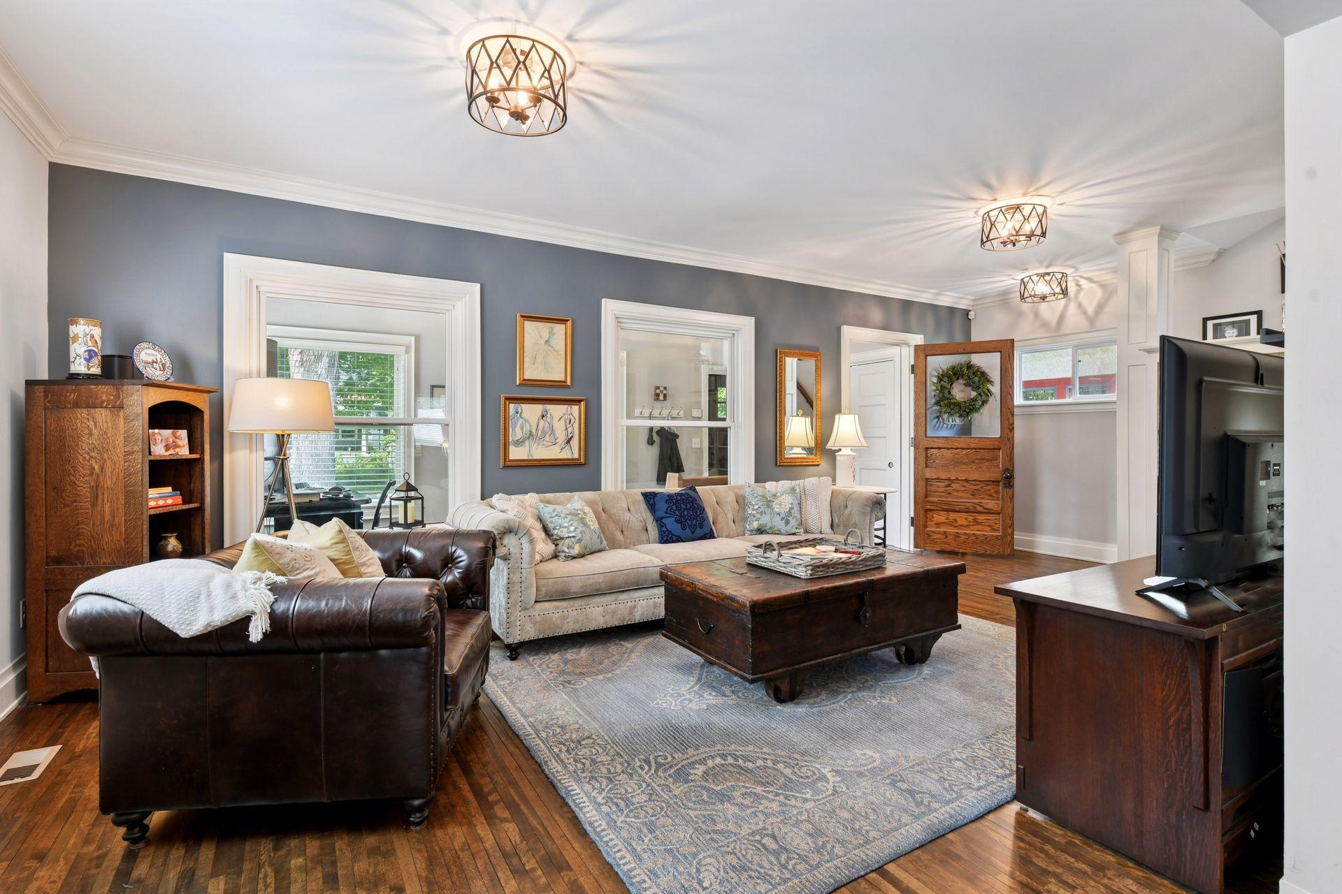 3837 Pleasant Avenue - The Living room - Stunning light-filled space with beautiful architectural details like hardwood flooring, high ceilings and crown molding.