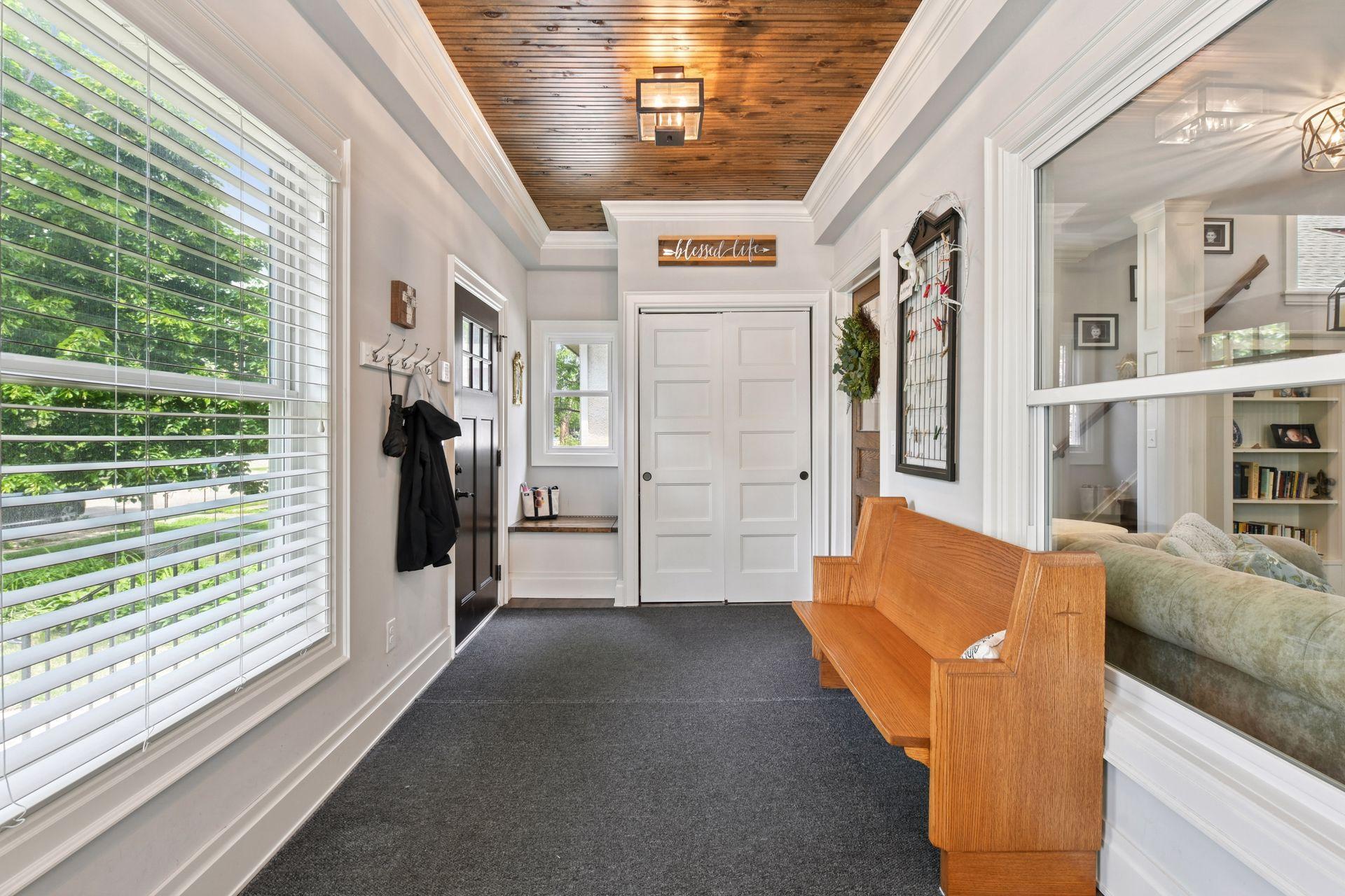 3837 Pleasant Avenue - Another view of the spacious Four Season Front Porch! It's easy to keep this mudroom area clean with the closet and corner bench storage.