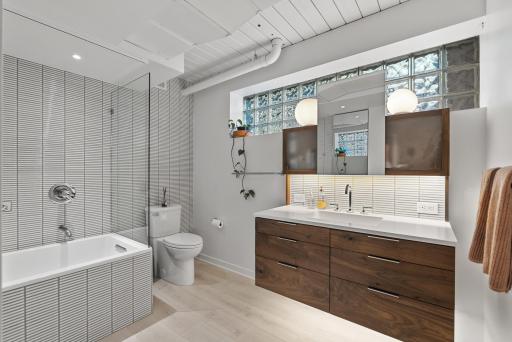 The two lower-level bedrooms share this renovated and roomy bathroom.
