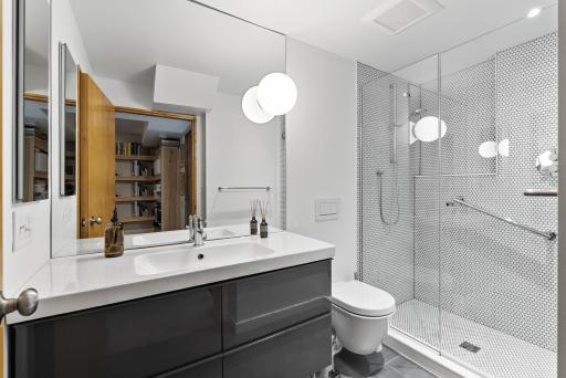 The guest suite's bathroom has a walk-in shower and plenty of storage.