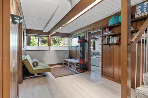 The lowest level of the home has a common lounge flanked by two bedrooms, a full-sized bathroom, and a laundry room.