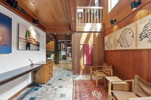 Tiled floors and beautiful wood great you upon entry.