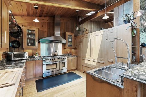 Here, you will find a BlueStar range and an abundance of customized storage options.