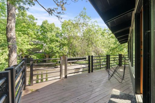 The balcony off the upper family room provides a tranquil space to listen to birds or enjoy some shade.