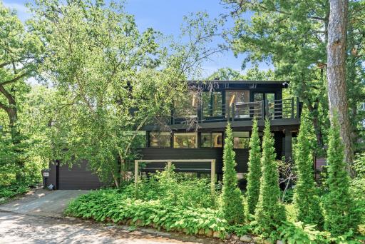 Nestled in the Burnham Woods neighborhood, this mid-century modern gem sits on a lush, green lot just steps from Cedar Lake.