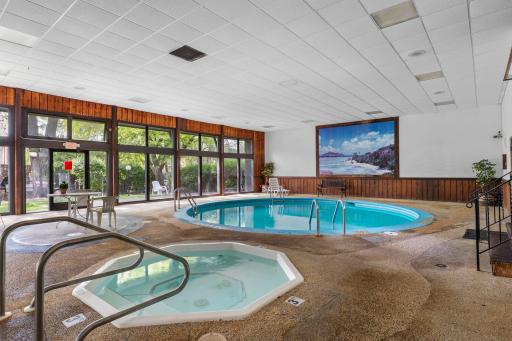 Pool and hot tub walks out to patio with grilling area