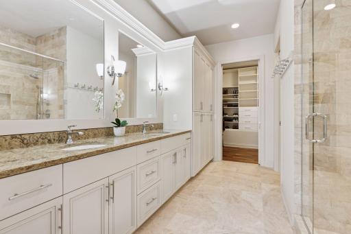 Primary bathroom with large walk-in closet, two sinks and water closet