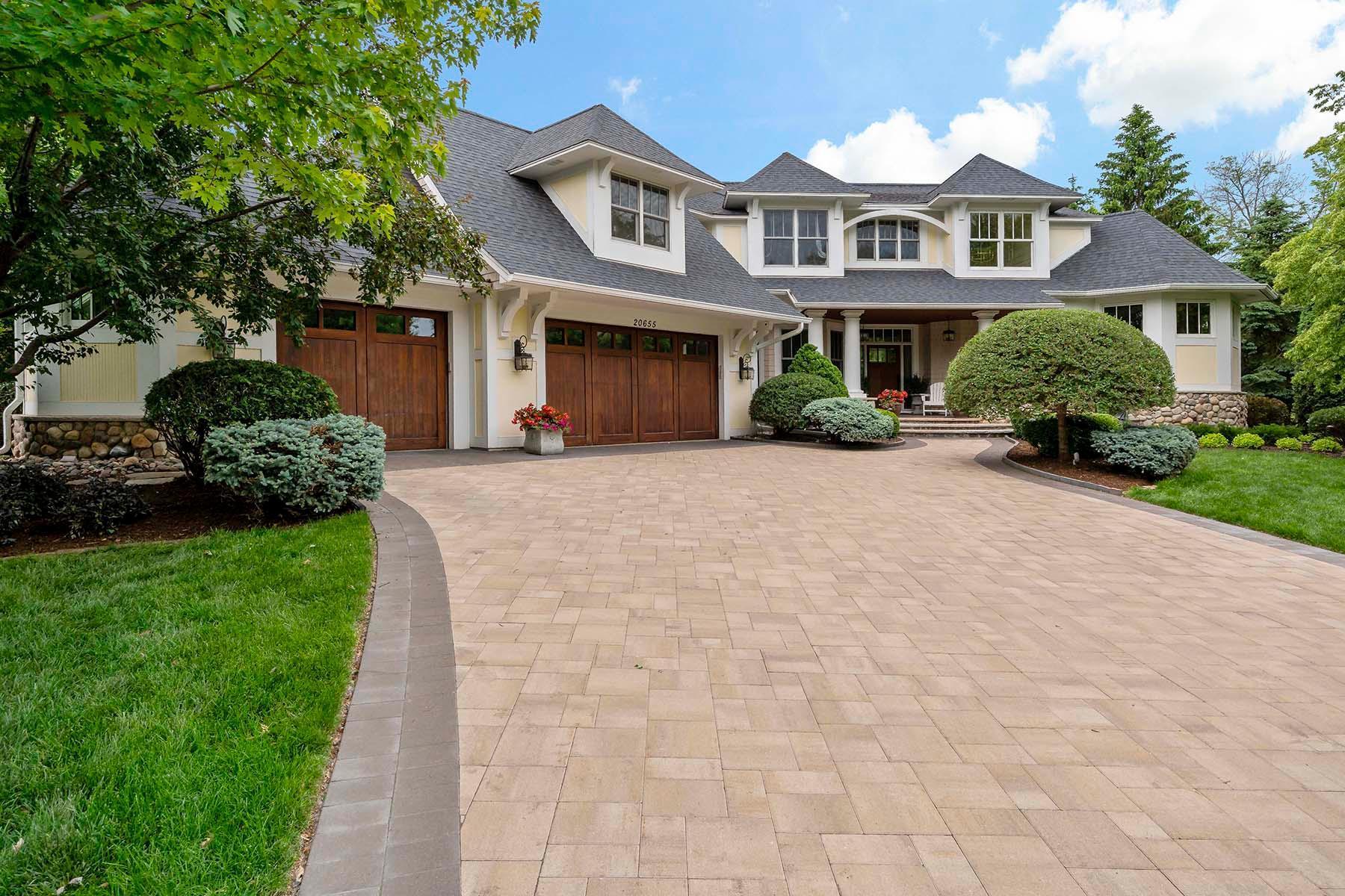 Custom stone paver driveway, heated garage with built-in cabinets and alcove for storage