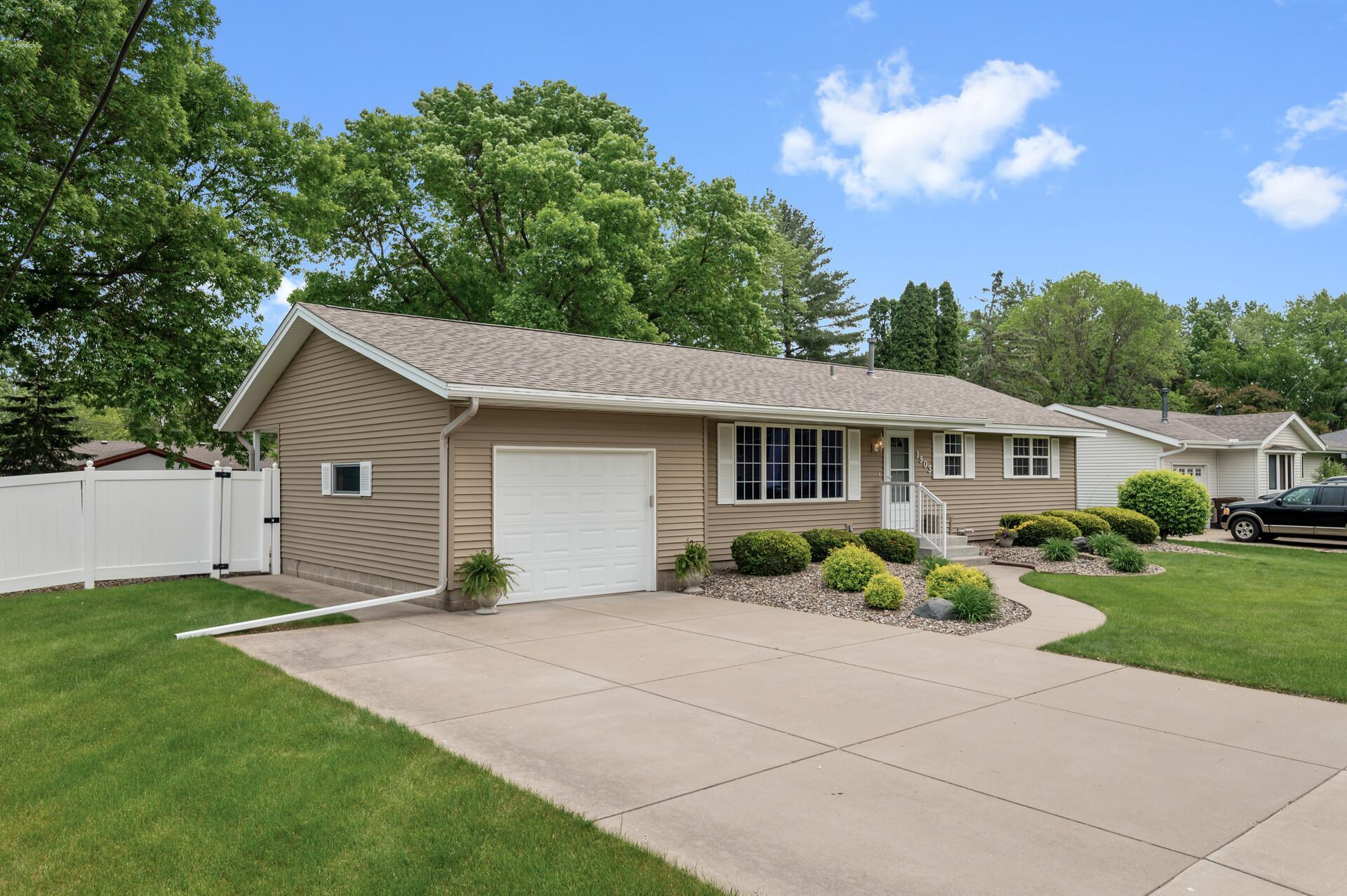 Wide concrete driveway provides extra parking for guests
