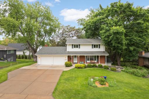 Charming front porch on this two story home! Newer concrete driveway.