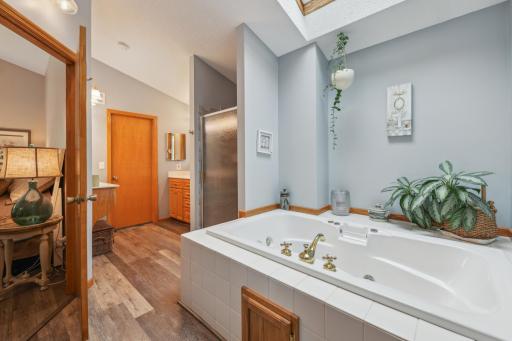 Spacious primary bathroom with jetted tub & walk-in shower