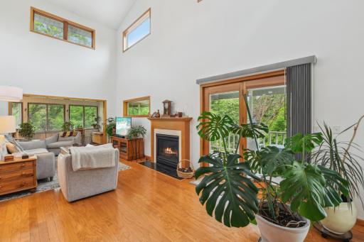 Vaulted living room features hardwood floors & a gas fireplace