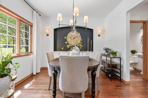 Built in buffet with quartz countertop, designer lighting, floor to ceiling drapery.