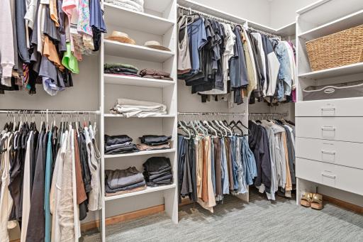 Large master closet with custom closet organizers.