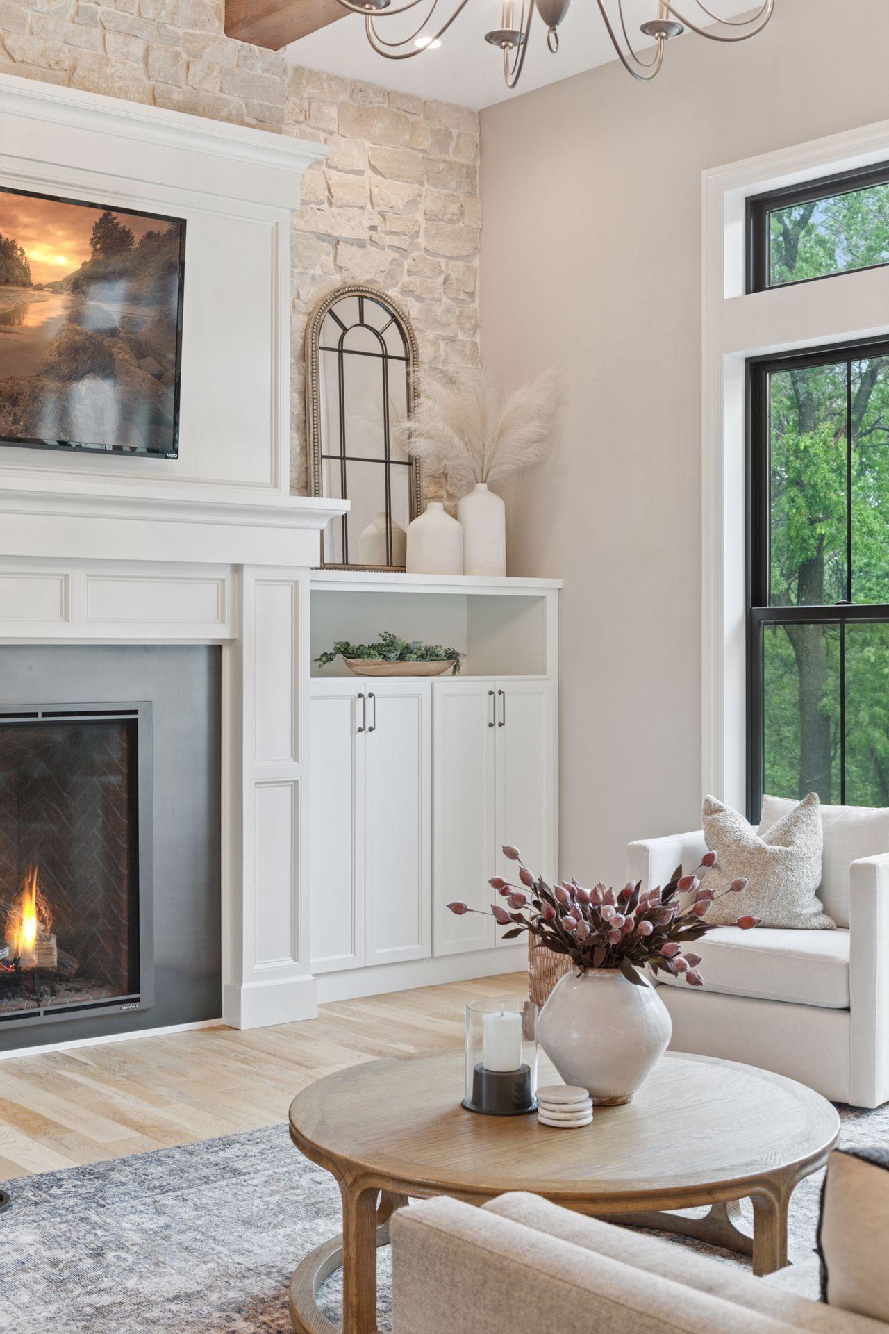 Close-up of the custom stone and millwork surrounding the gas fireplace, showcasing timeless design elements and upscale finishes.