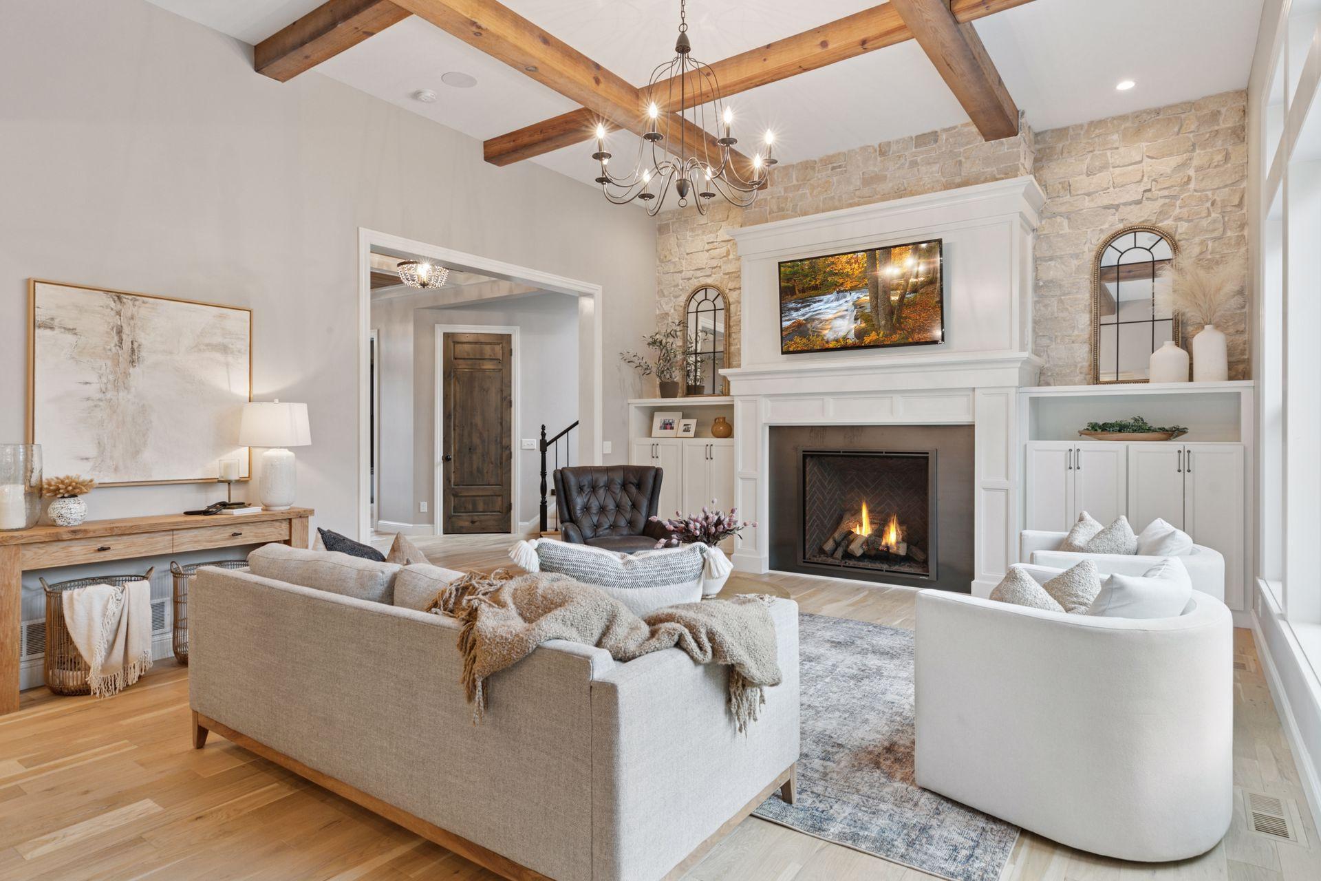 Elegant vaulted ceiling with exposed beams and a centerpiece fireplace, ideal for relaxing or entertaining in style.